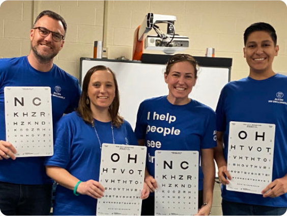 Alcon Associates holding eye charts