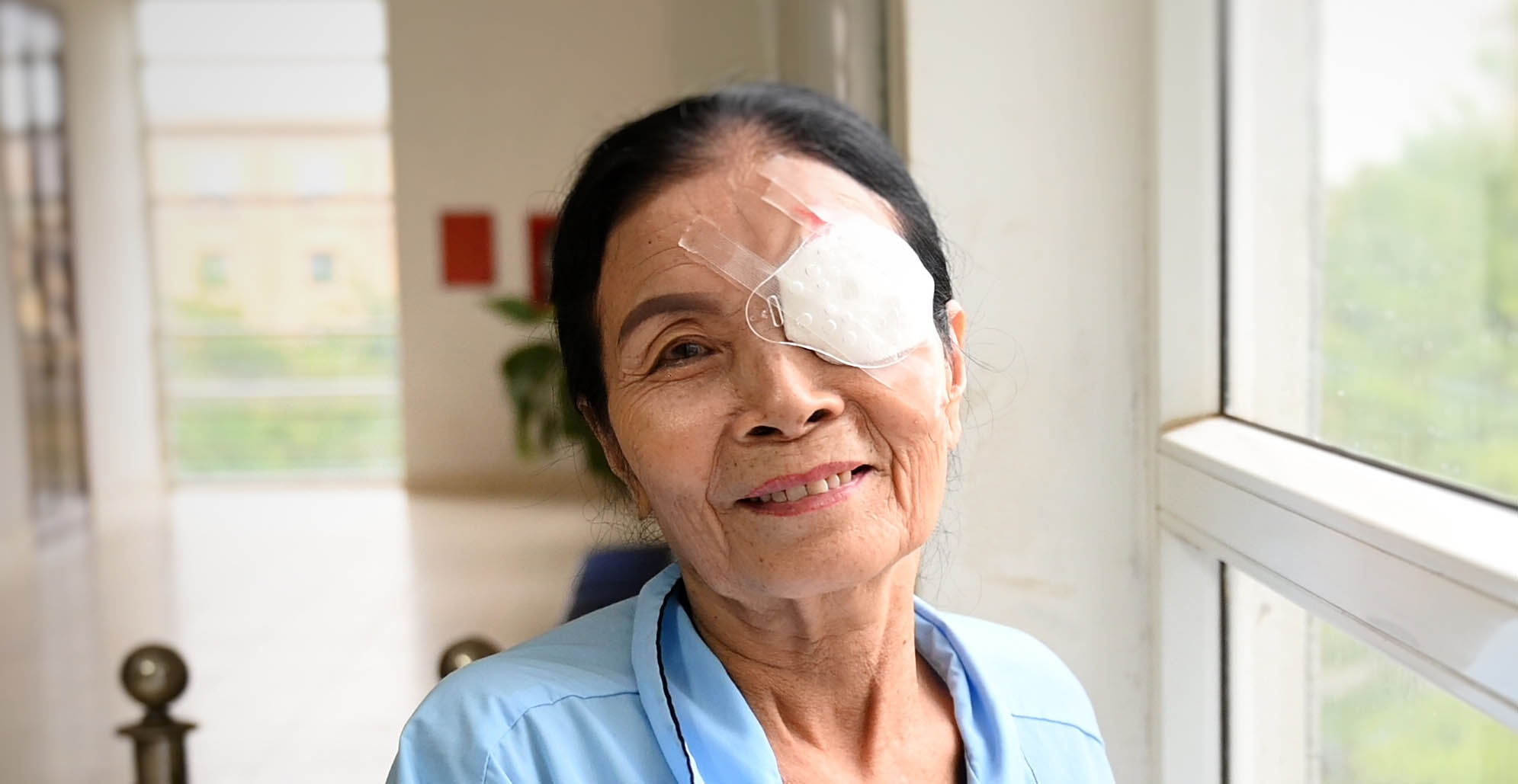 Female patient with bandage over one eye