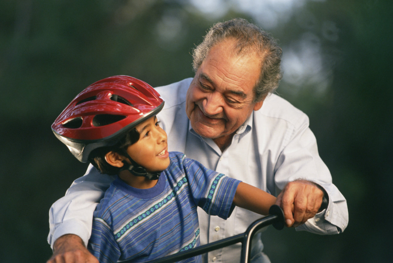 Older gentleman and a child riding a bicycle