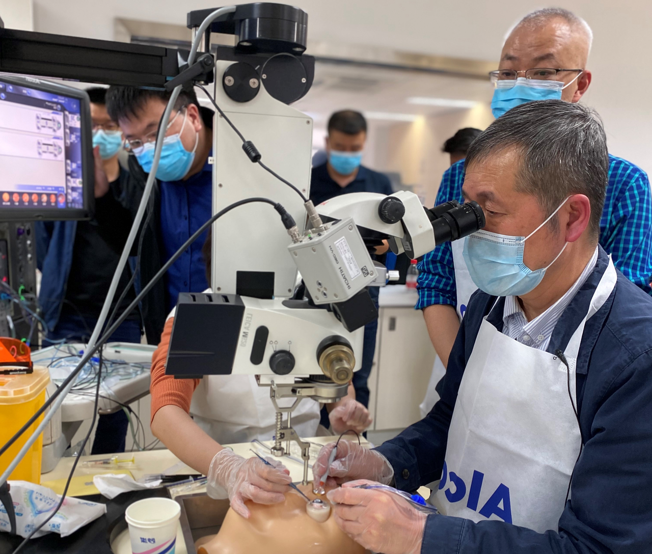 Eye care professionals receiving hands-on surgical training