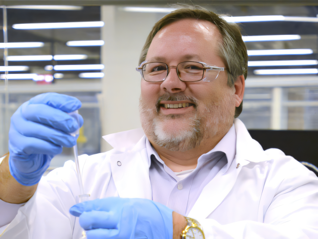 Smiling lab tech with pipette
