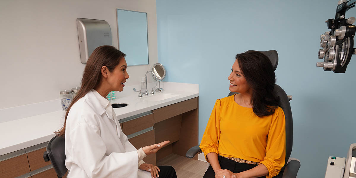 Eye care professional speaking with patient