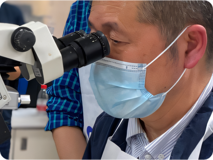 Doctor looking into microscope