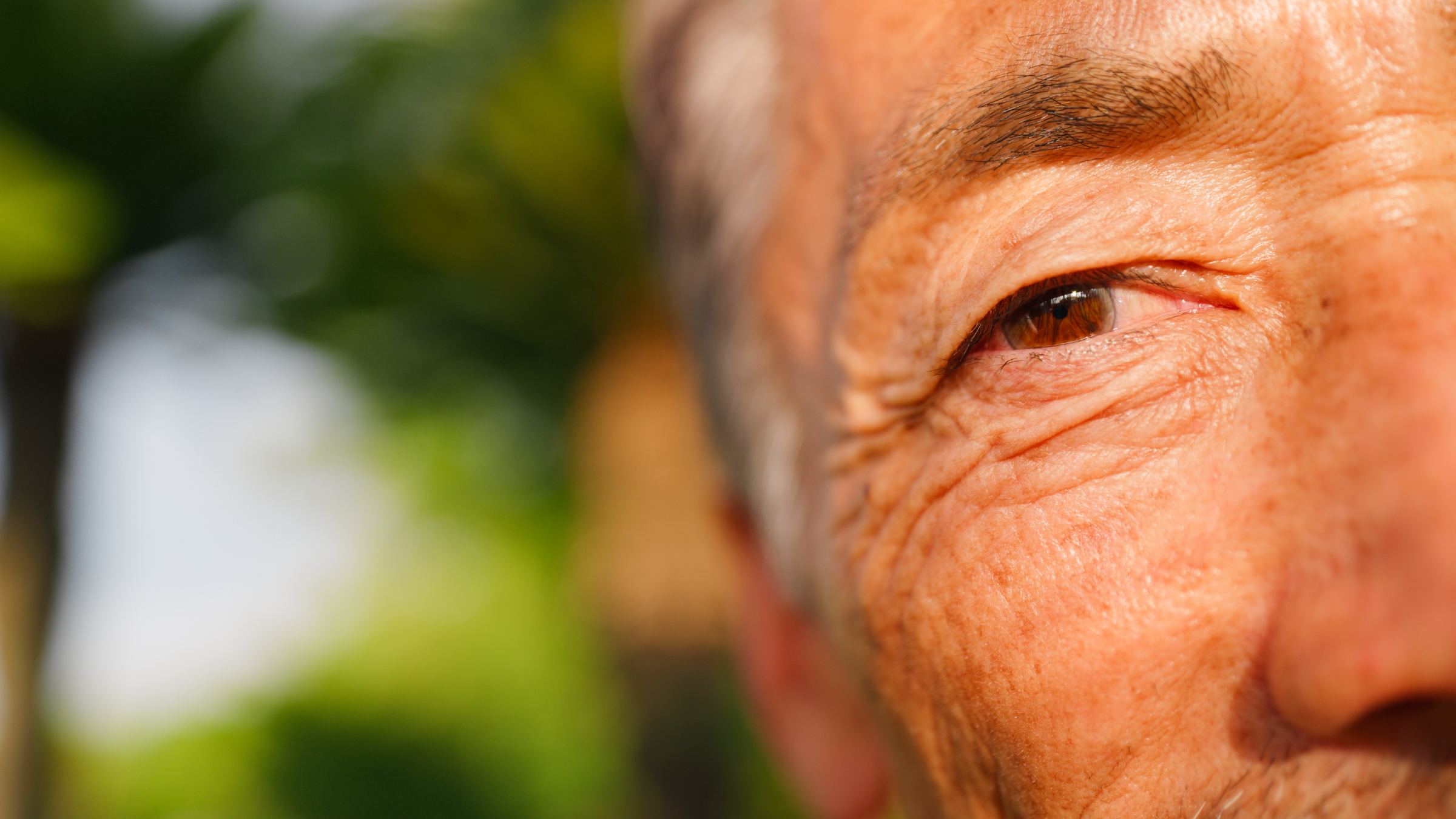 Closeup of side of older man's face focusing on his eye