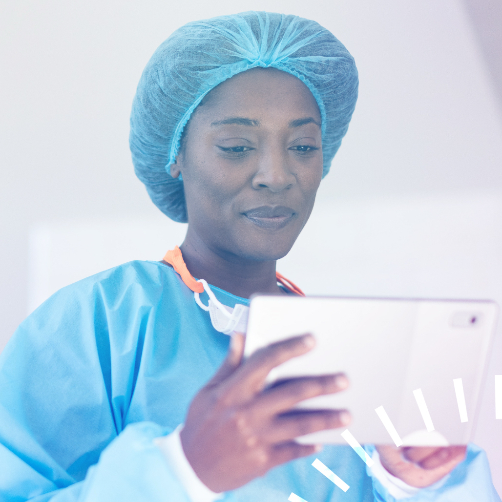 Healthcare professional in scrubs looking at a tablet
