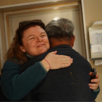 Patient and eye health professional hugging