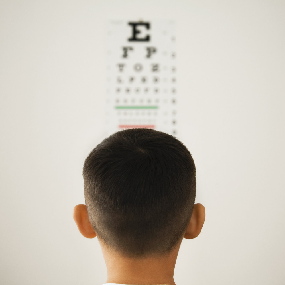 man looking at an eye chart