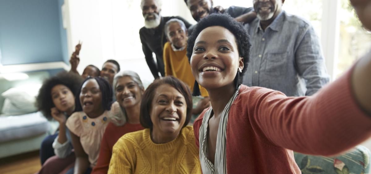 Group of people smiling and taking a selfie photo