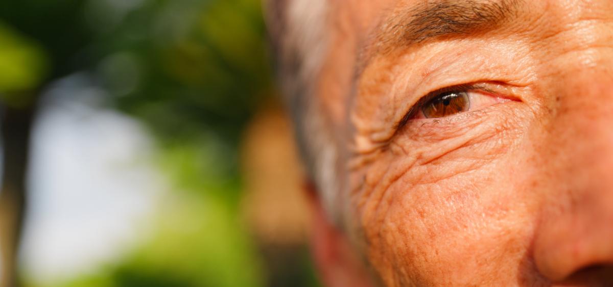 Closeup of side of older man's face focusing on his eye
