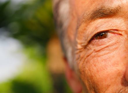 Closeup of side of older man's face focusing on his eye