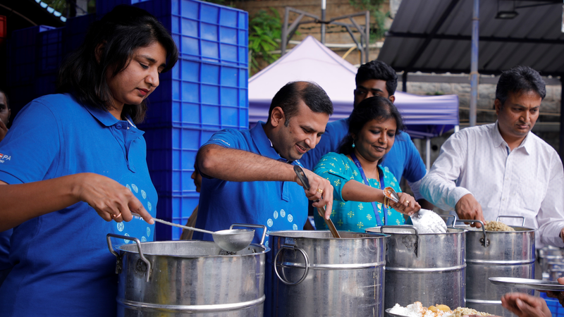 Alcon employees serving food