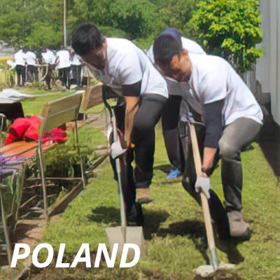 Alcon volunteers using shovels to dig in a volunteer effort in Poland
